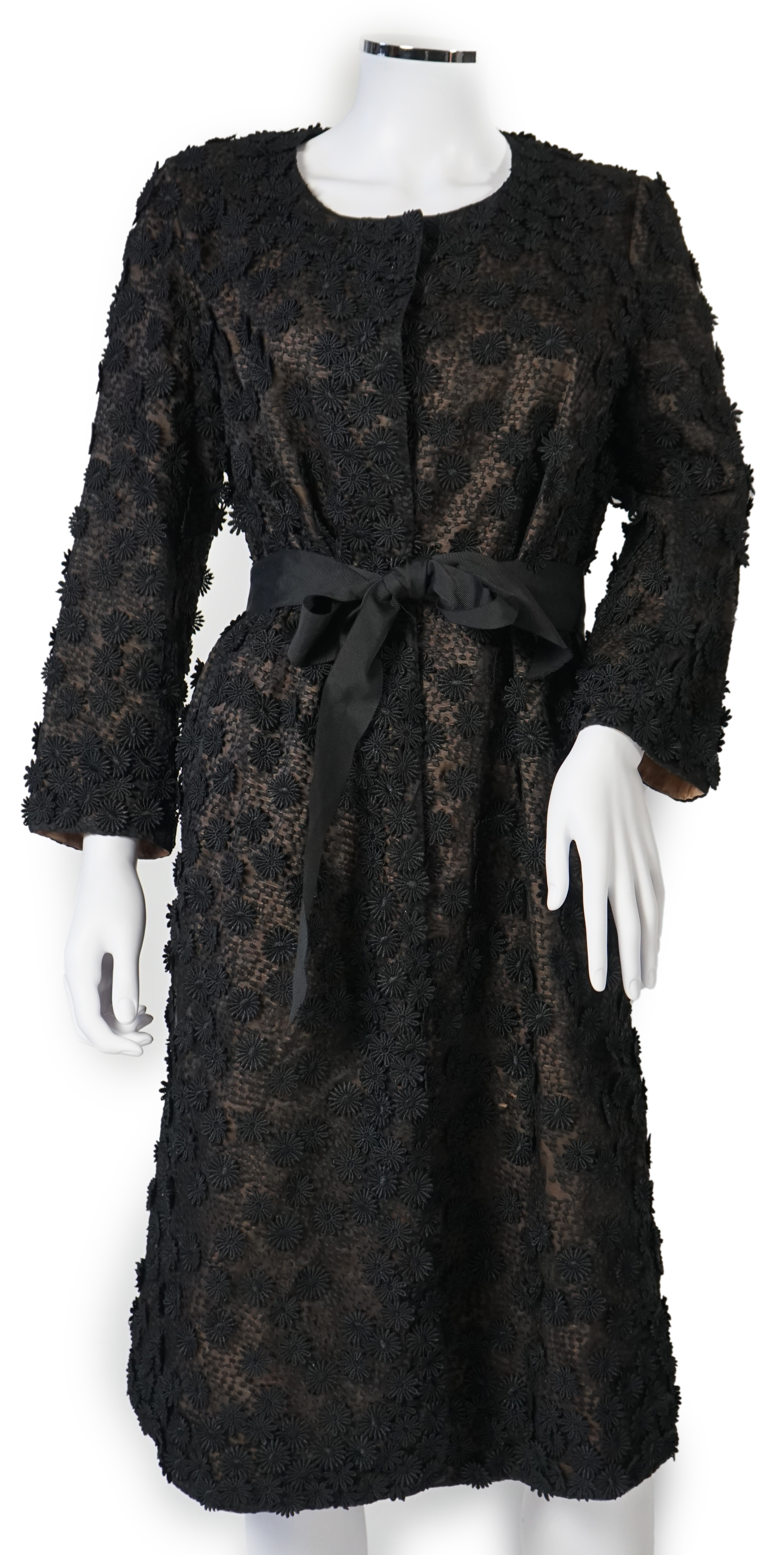 A Nicole Farhi lady's black lace knee length jacket with flower embellishment all over with black ribbon tie belt, size 12